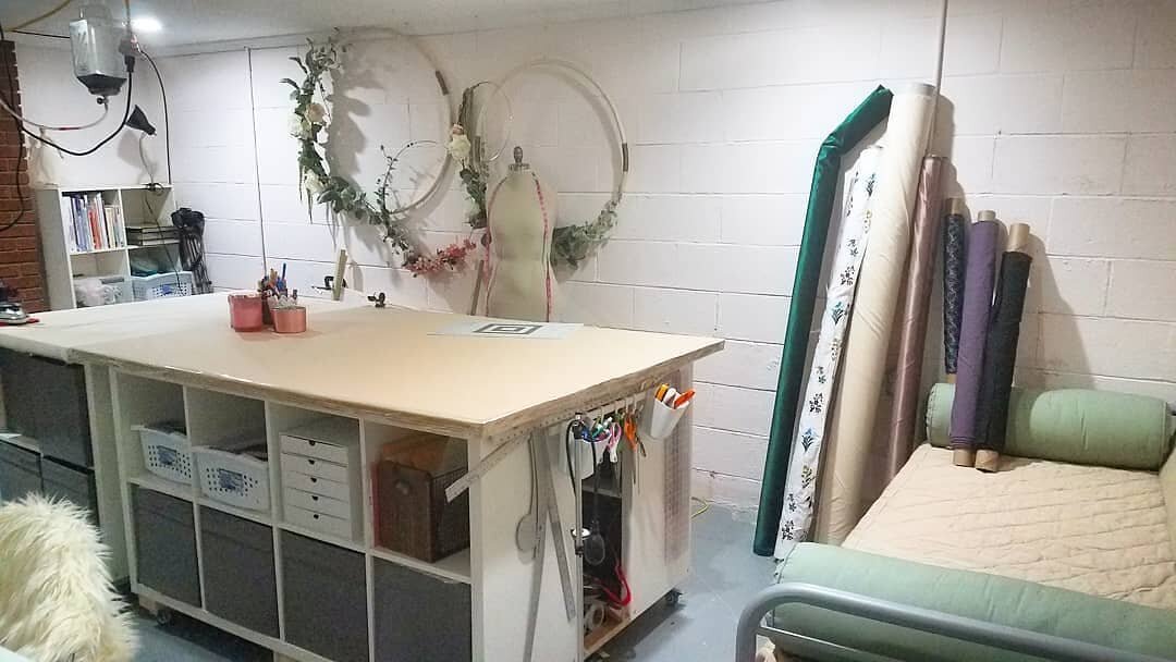 Ode to my craft room, which has been cleaned to the point of near unuse for the purpose of real estate photos (you can't see the stuff hidden behind the table). Note the creative rolls of fabric placed to hide the worst of the moisture stained founda
