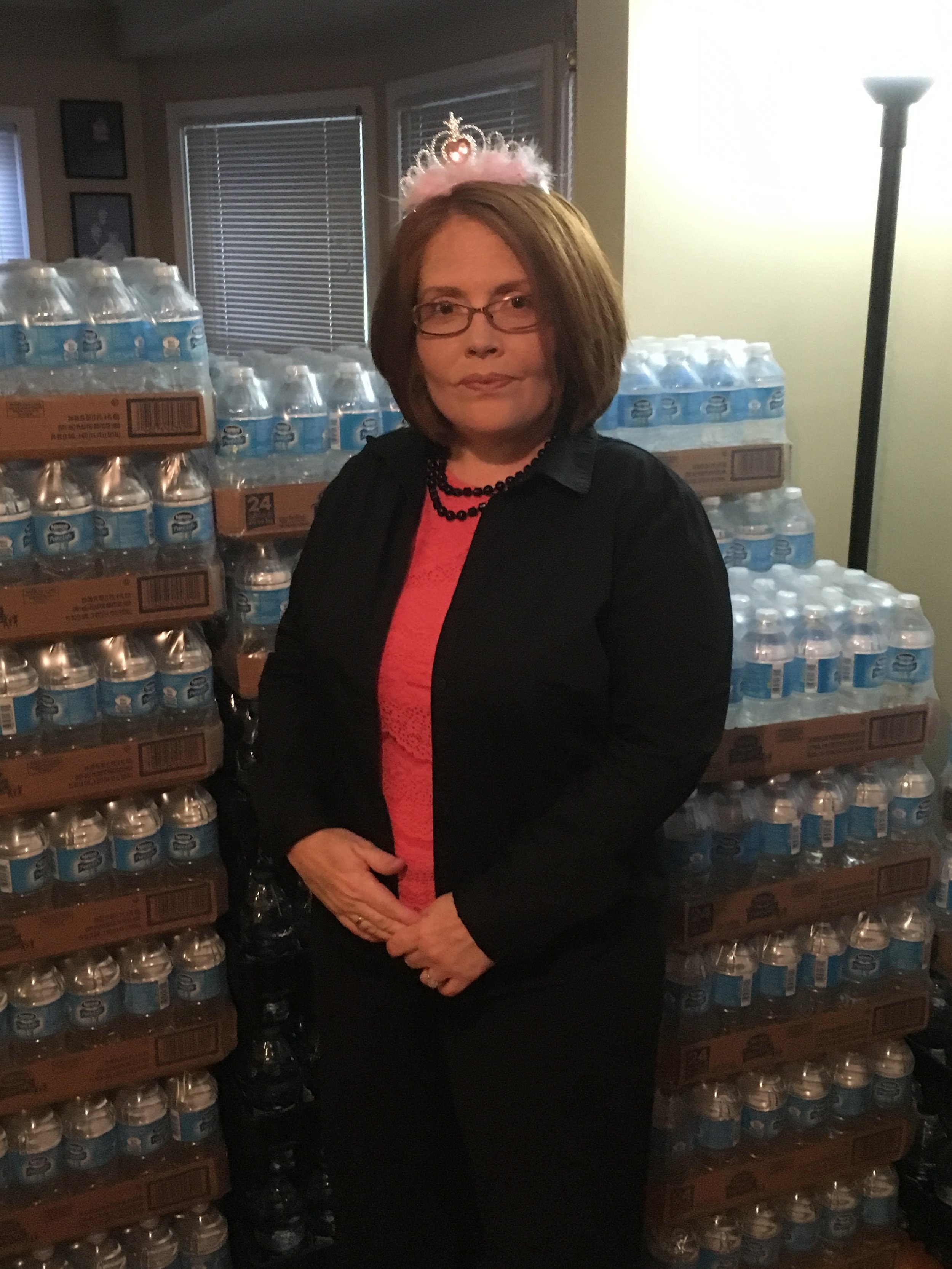 Amy Brown standing in front of water inside her home