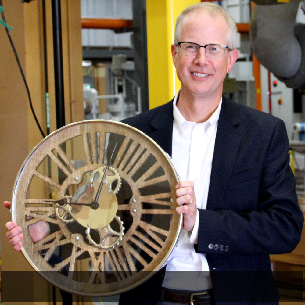   SMMPA Executive Director and Chief Executive Officer Dave Geschwind poses with a clock that was bestowed as a gift to the Owatonna Energy Station.  