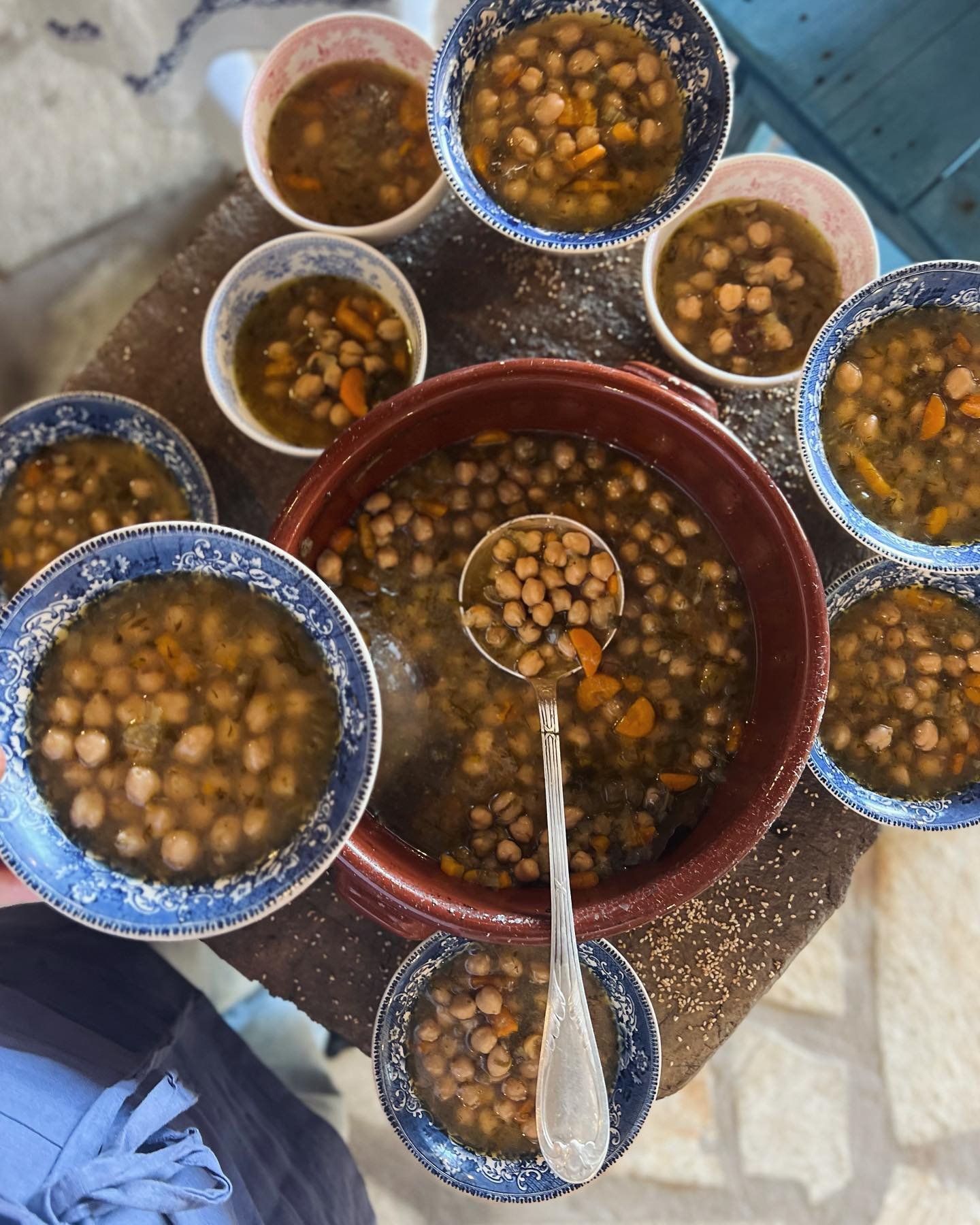 Lunch today at Melisses - brothy chickpeas cooked slowly overnight in the wood oven, with beautiful sourdough koulouri by @joshshuffman. Lamb slow cooking in the background for this evening. 
.
.
.
#woodfired #sourdough #koulouri #slowcookedchickpeas