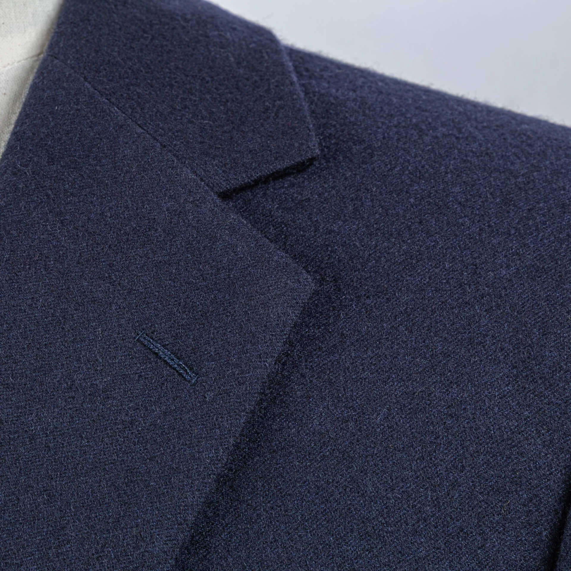 Detail van natuurlijke schouderconstructie blue melange colbert, clean lijnen zonder opvulling, klassiek Brits maatwerk