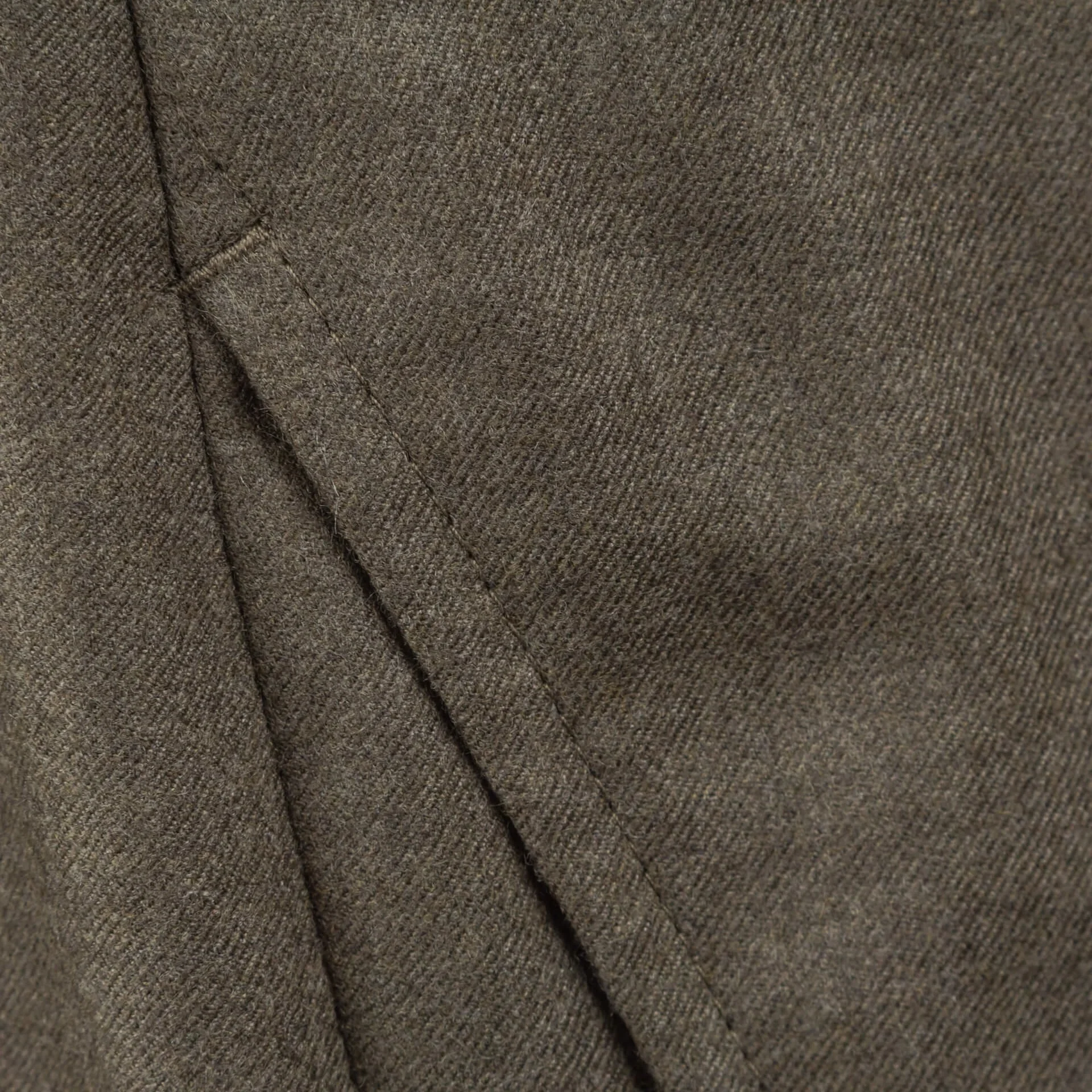 Close-up van handgemaakte pick stitching langs steekzak op oatmeal worsted flannel broek