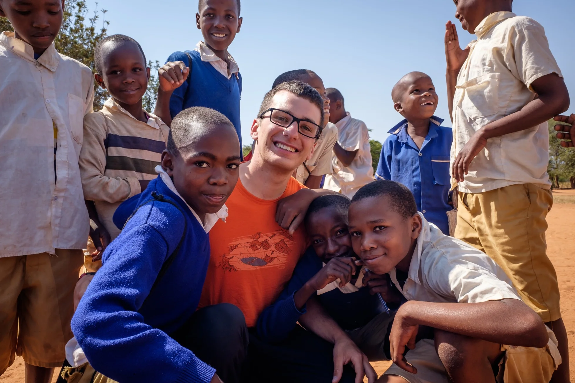During one of our village visits, students from a local primary school snapped this photo of me with some new friends while playing with my camera.