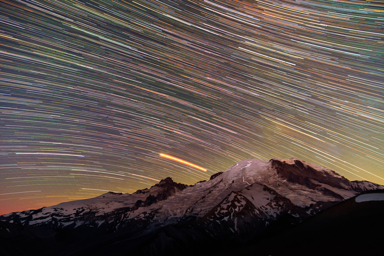 Climbers on the Dissapointment Cleaver and Emmons-Winthrop Routes are visible in this 2 hour star trail exposure.