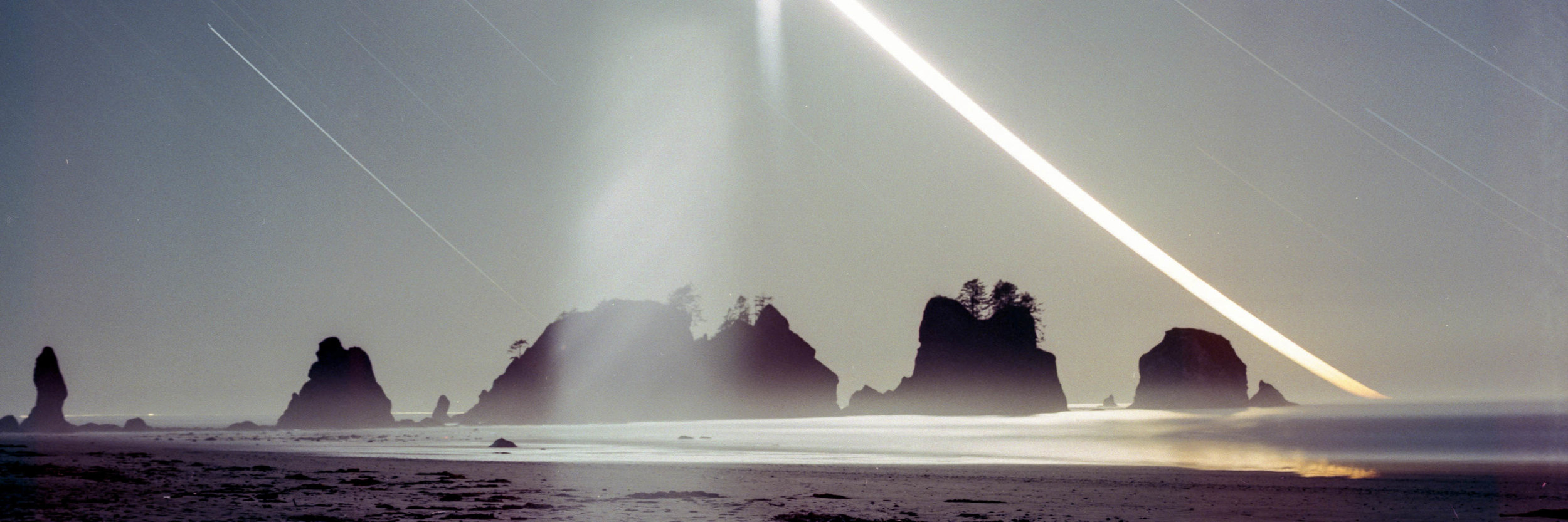  A 3 hour exposure of the moon setting behind sea stacks. The haze in the middle is glare from the moon. 