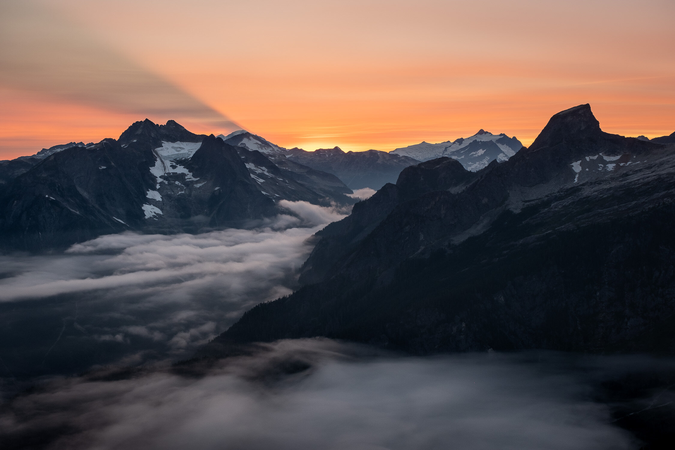  Mount Baker (behind Despair) casts its shadow onto the clouds at sunset 