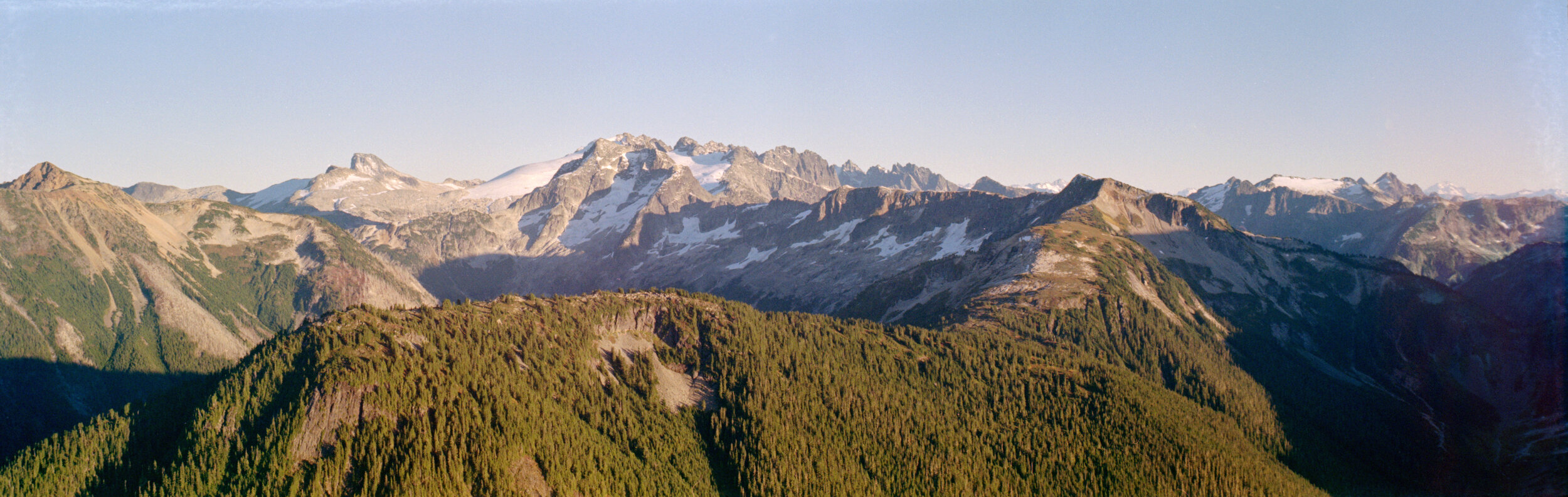  Luna Peak, Whatcom Peak, and Mount Challenger (inline), above Easy Ridge in the late afternoon, from Copper Lookout. Crowder, Pioneer Ridge, Despair, and Glacier at right. Kodak Gold 200. 