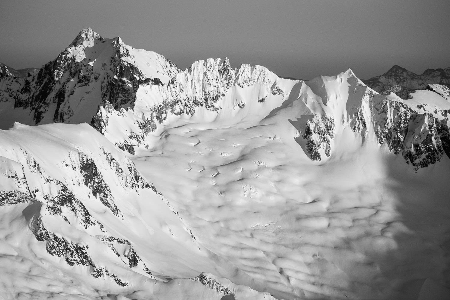  Boston and Sahale Peaks, with the Quien Sabe Galcier beneath. Sharkfin Tower at left, below Buckner which is inline with Goode at upper left. 