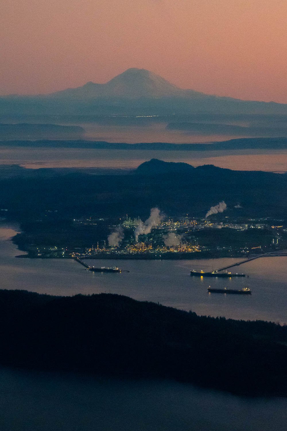  Mount Rainier and Anacortes oil refineries at dusk. 