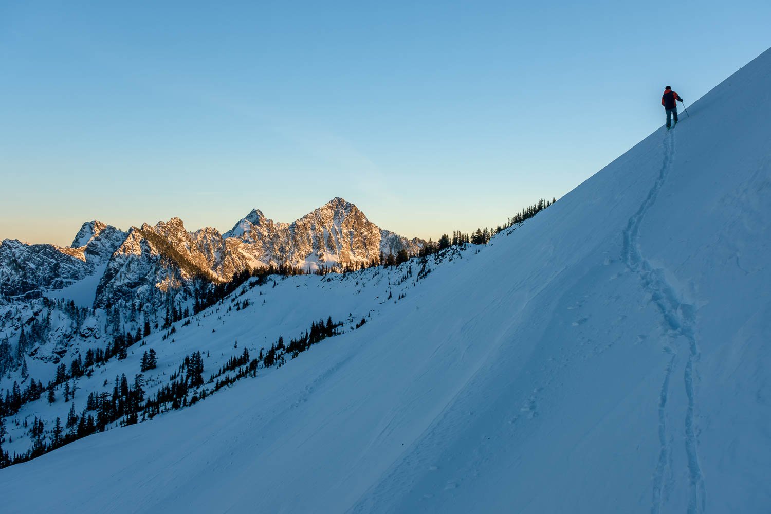  Matt climbing the slopes of Mount Caroline for sunset. Roosevelt, Chair, and Kaleetan at left. 