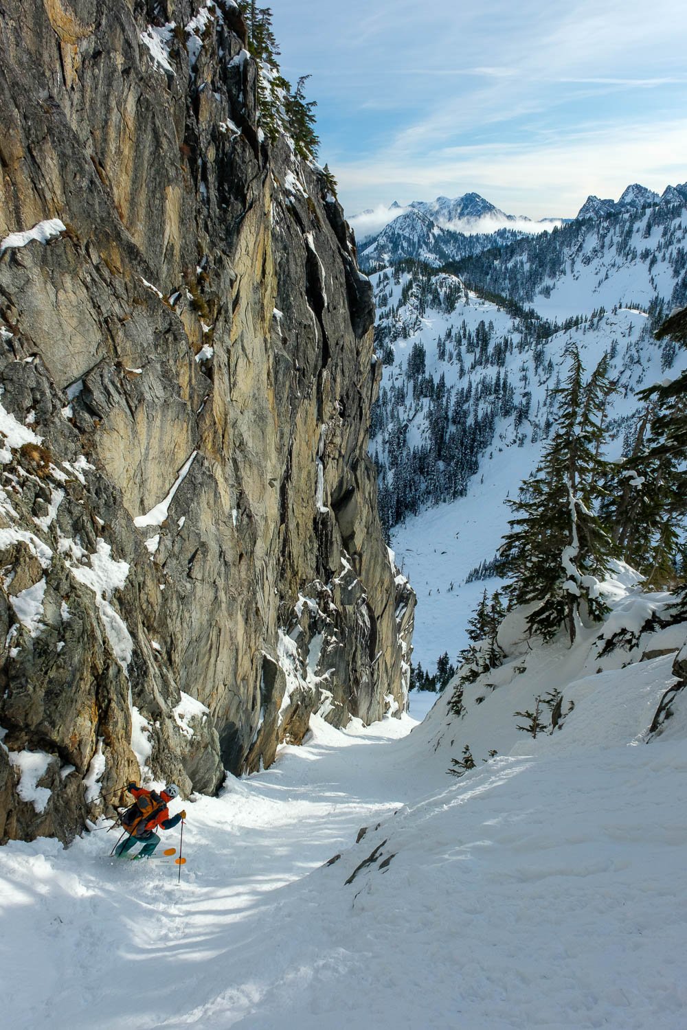 Matt skiing the Preacher Mountain Couloir. Mount Snoqualmie with clouds in the distance. 