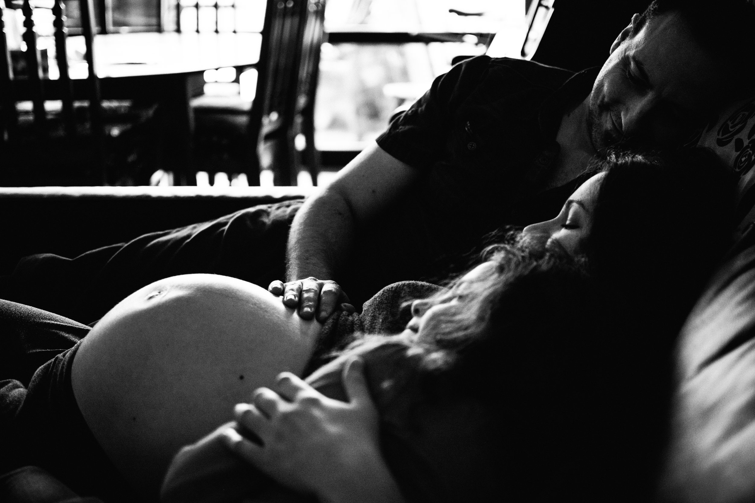 photo-noir-et-blanc-d-une-famille-qui-atteint-la-venue-d-un-petit-frere-sur-le-divan-photographe-maternite-bebe-famille-montreal.jpg