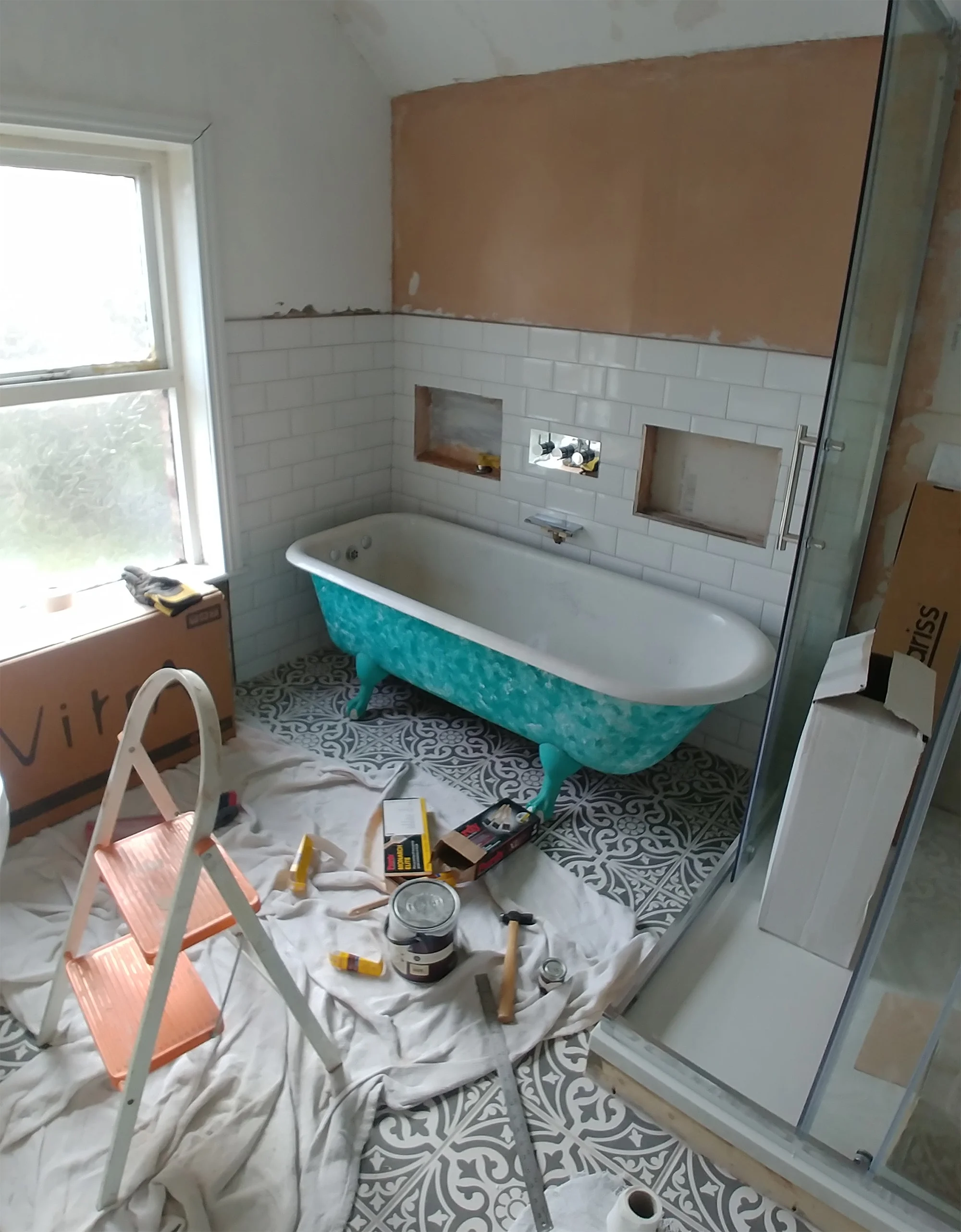 Floor, wall tiles and shower surround done. Shower tiles, sink, bath and decorating yet to do.