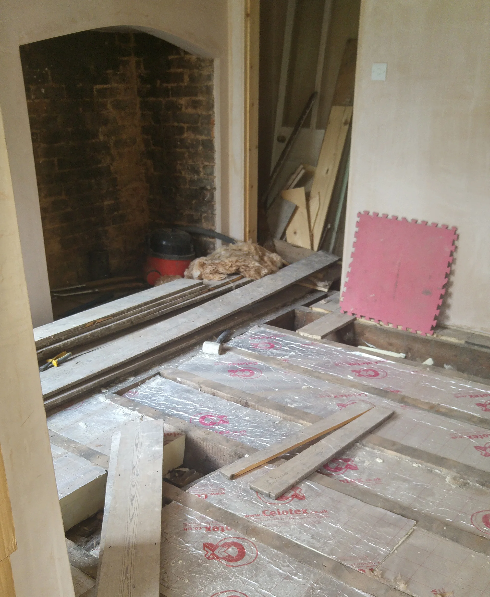Laying Celotex boards in the playroom.