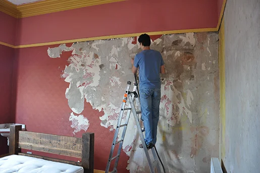 Taking the wallpaper off, along with most of the plaster underneath.