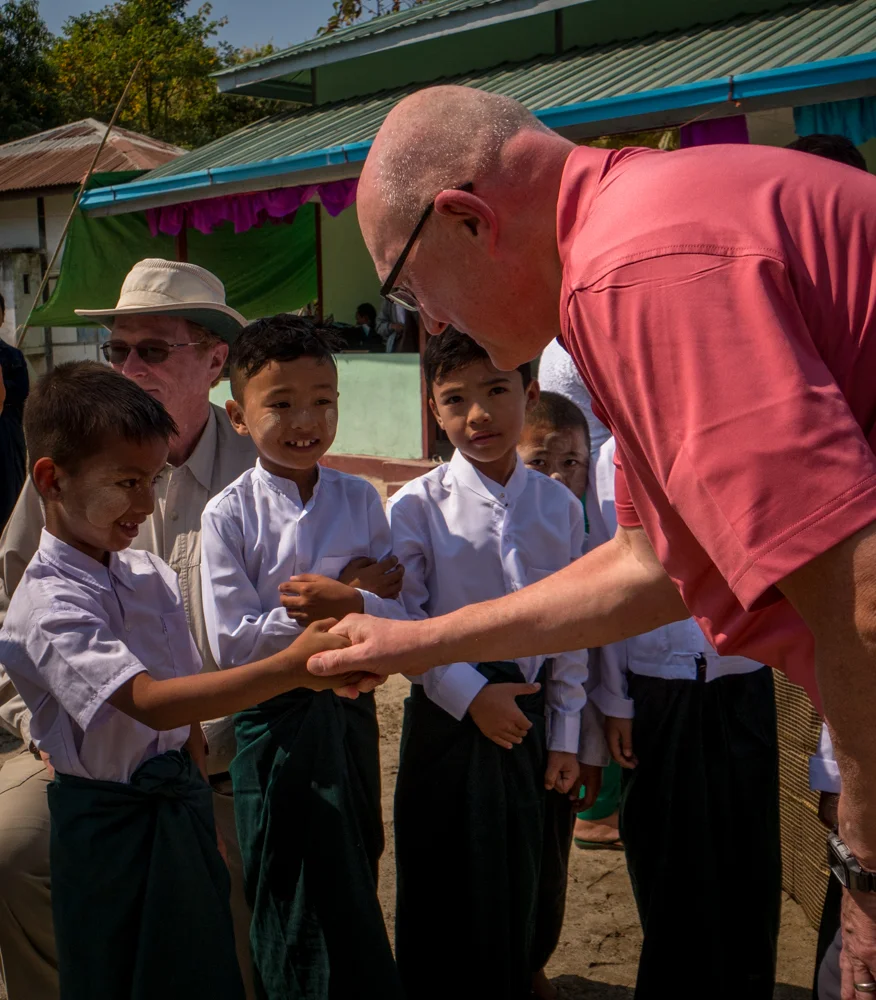 Keith Prescott visits with the children at a new school completion ceremony : the villagers there express an immense gratitude for the trust’s assistance