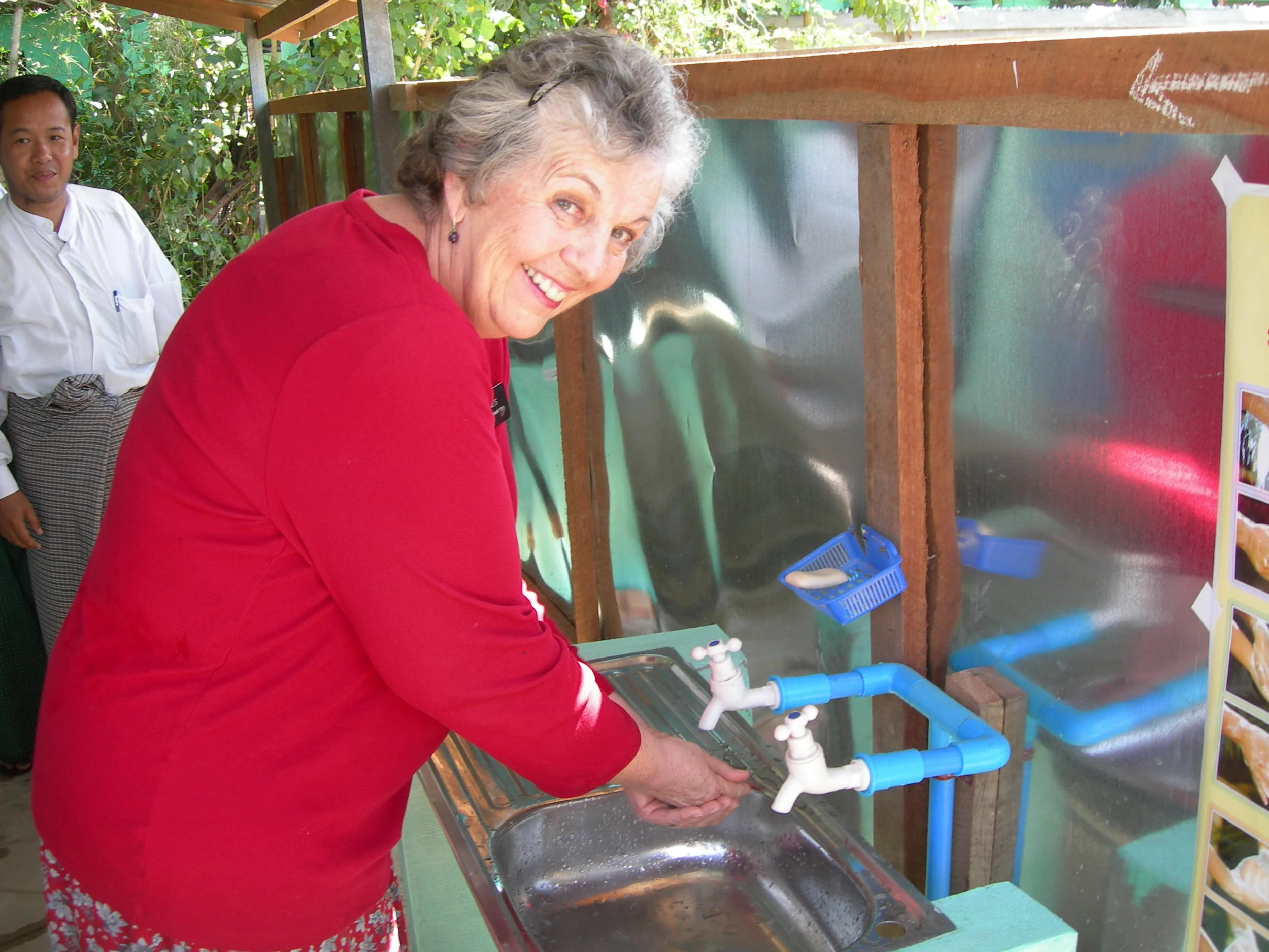 Jayne Jones at a new latrine: sinks & soap to wash after using the latrines are a wonderful new development for this village