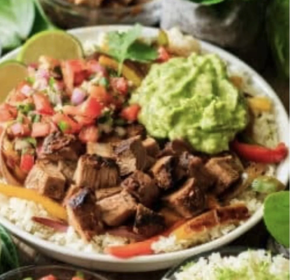 Sunday's Special is a Layered Mexican Bowl with Rice, Beans, Carne Asada, Cheese, Salsa, & Guacamole.