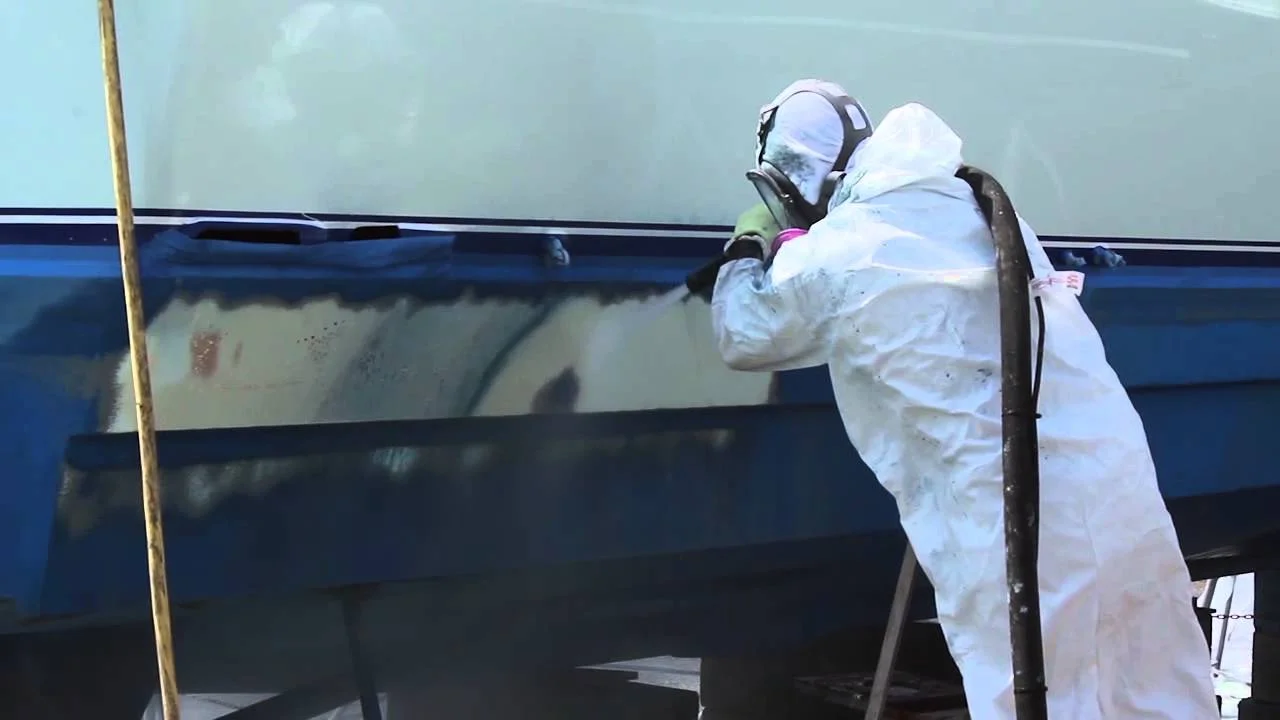 Removal of Antifouling boat bottom paint by dustless blasting.