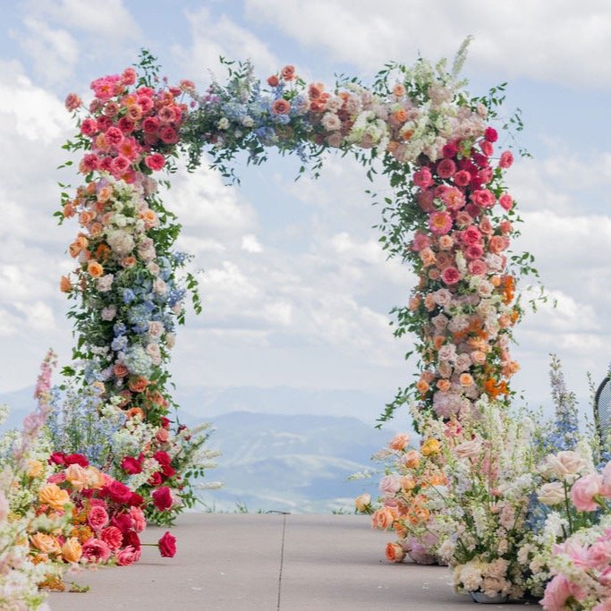One of the most memorable aisles we did in 2025. The colors were vibrant + textured, lush + layered. This was a playful design to create. We are here for all the colors that we had the opportunity to incorporate into the arch + aisle. 

@dianaedlinge