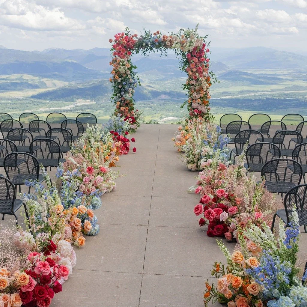 One of the most memorable aisles we did in 2025. The colors were vibrant + textured, lush + layered. This was a playful design to create. We are here for all the colors that we had the opportunity to incorporate into the arch + aisle.

@dianaedlinger