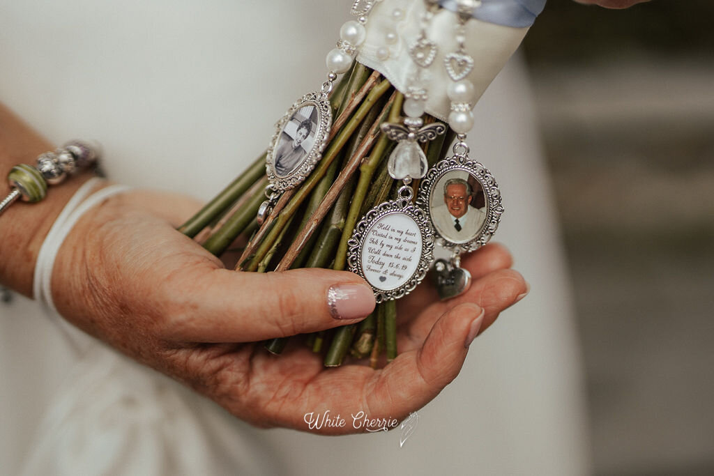Scottish Bride showing memorial charms on bridal bouquet by stunning flowers.