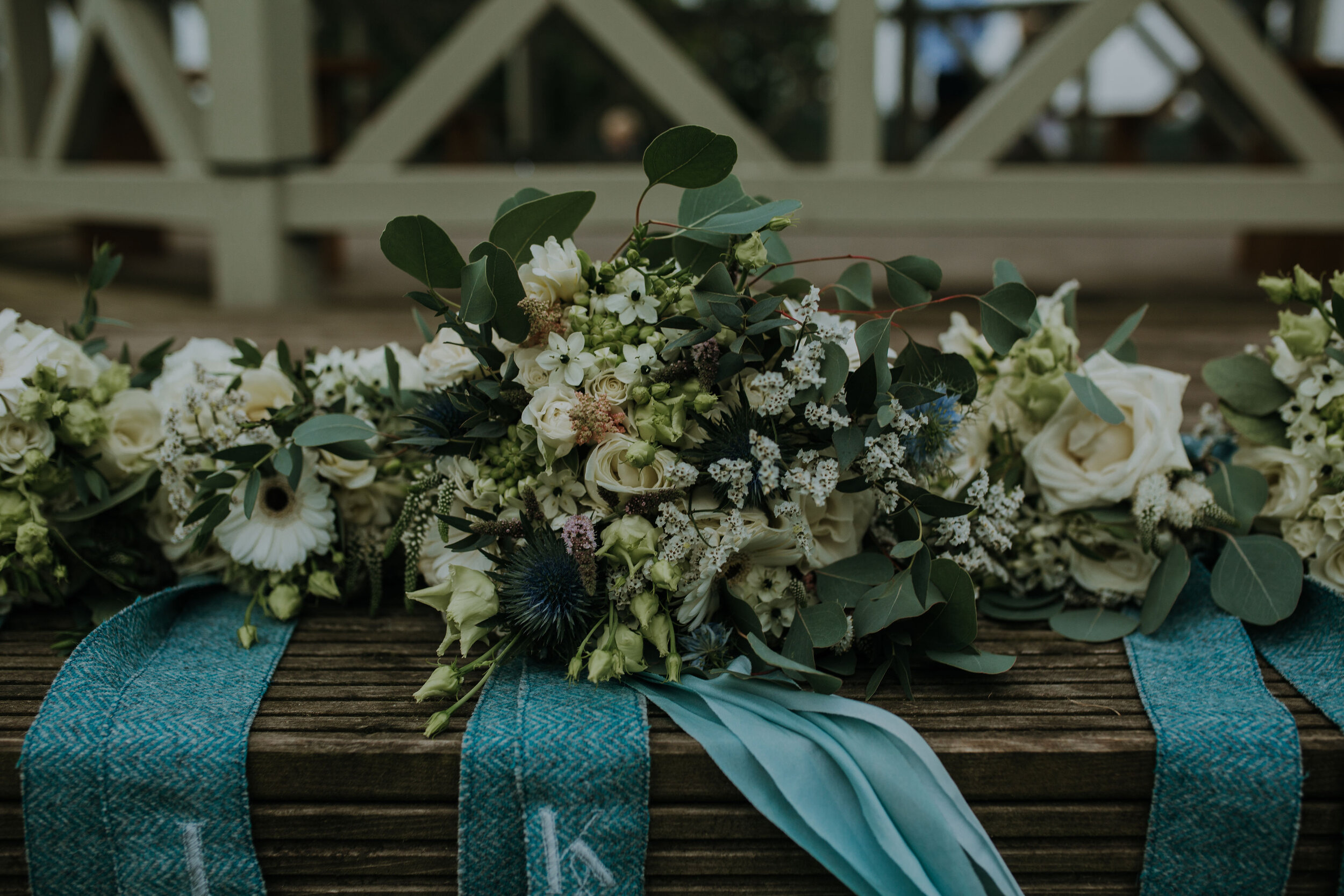 Beautiful Scottish wedding flowers with Harris Tweed ribbon at Perthshire wedding venue.