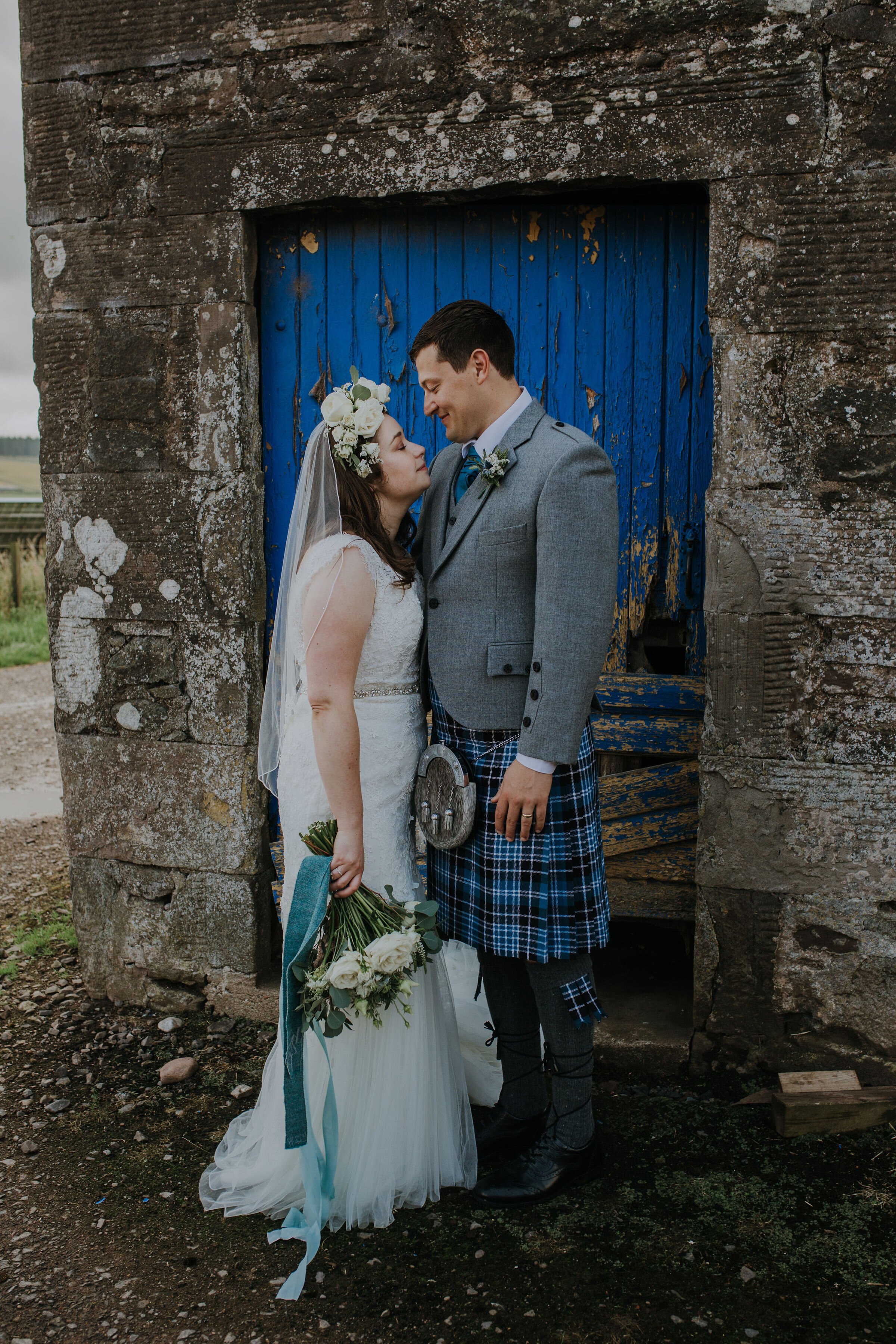 Scottish Bride and Groom at Bachilton Barn, Perthshire holding bridal bouquet. 