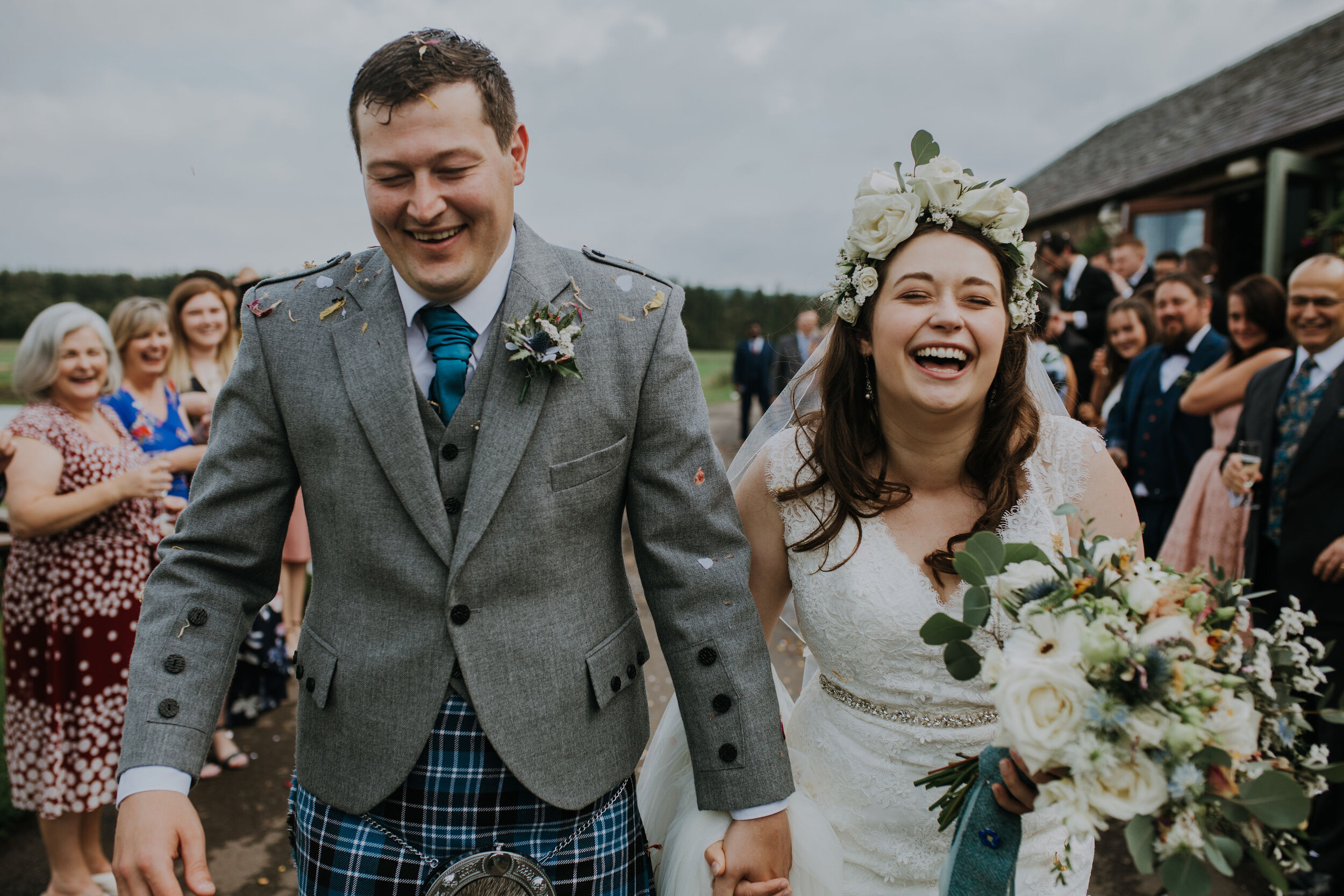 Scottish Bride wearing white floral crown alongside her groom at Bachilton Barn, Perthshire