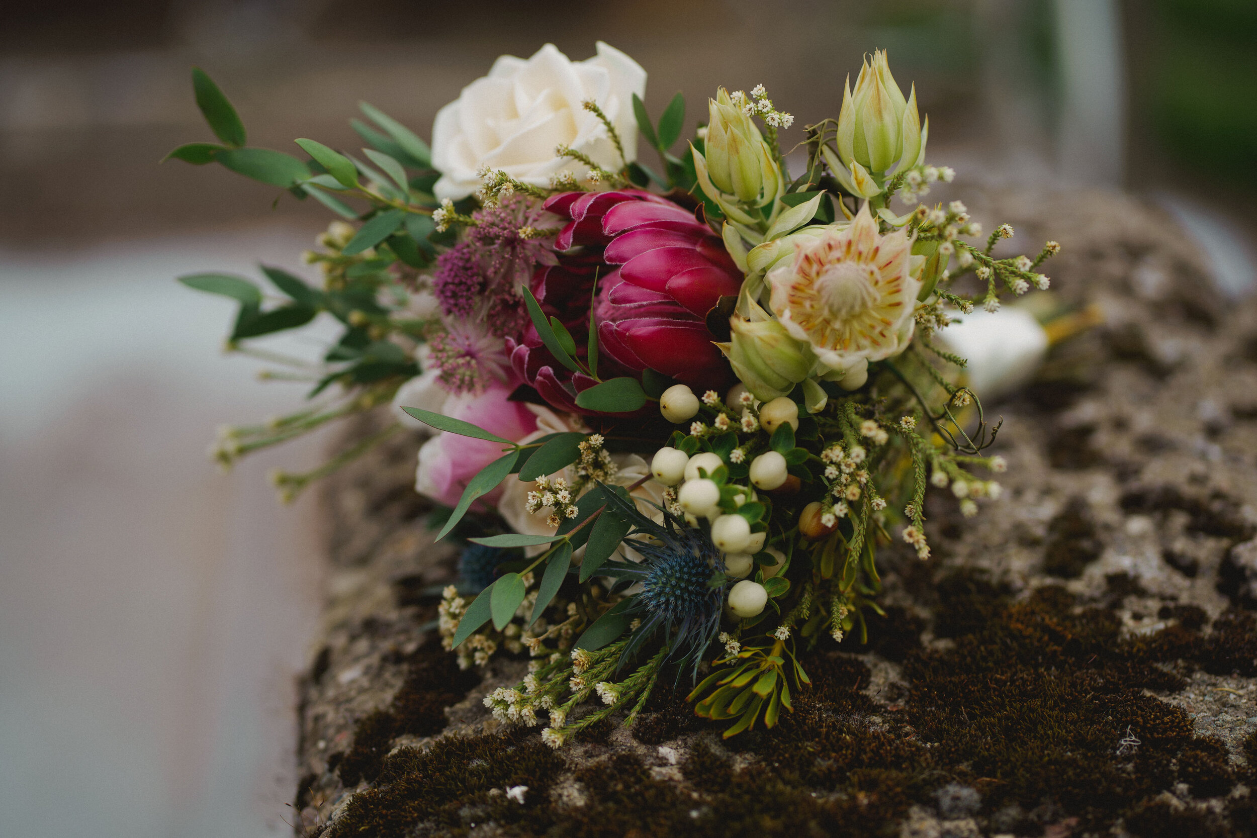 Bridal bouquet of white berries, cream roses and eucalyptus.