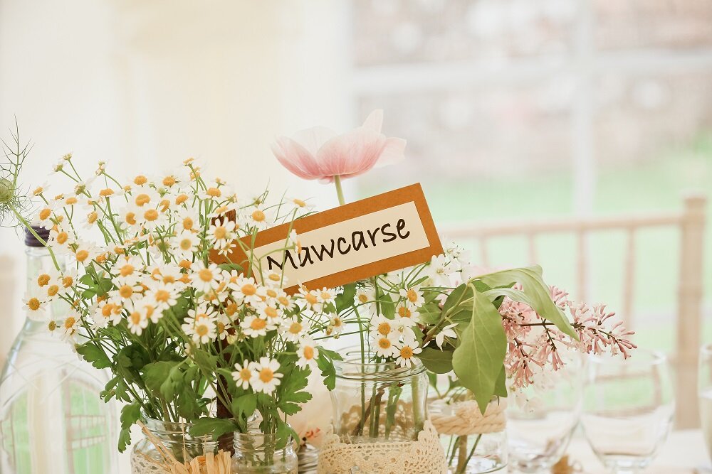 Jam jars filled with Scottish grown flowers at Perthshire wedding 
