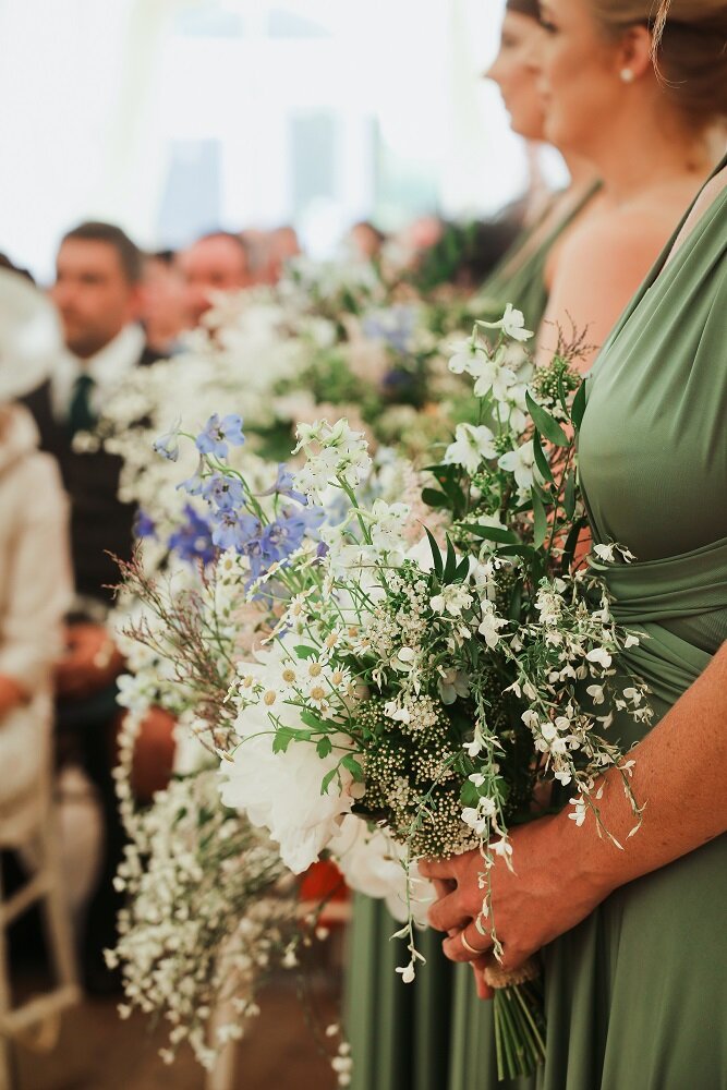 Bridesmaids holding bouquets of peony and delphinium at Scottish wedding 