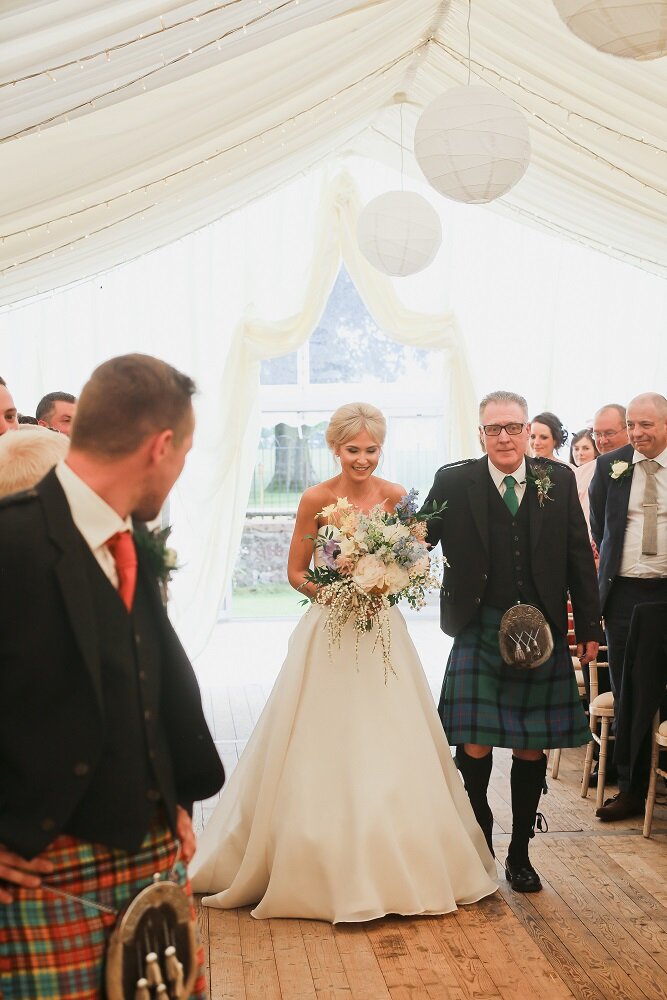 Father of the groom walking bride down the aisle at Scottish wedding