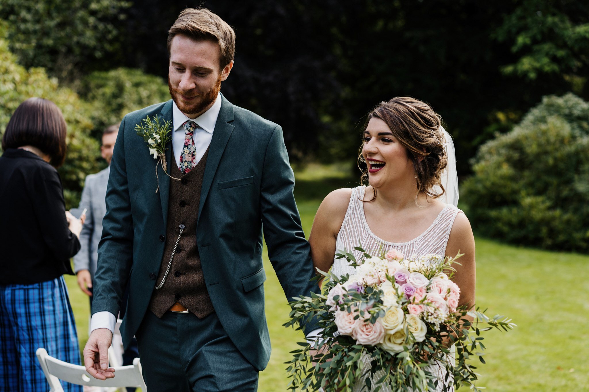 Bride and groom walking up the aisle after Scottish outdoor wedding 