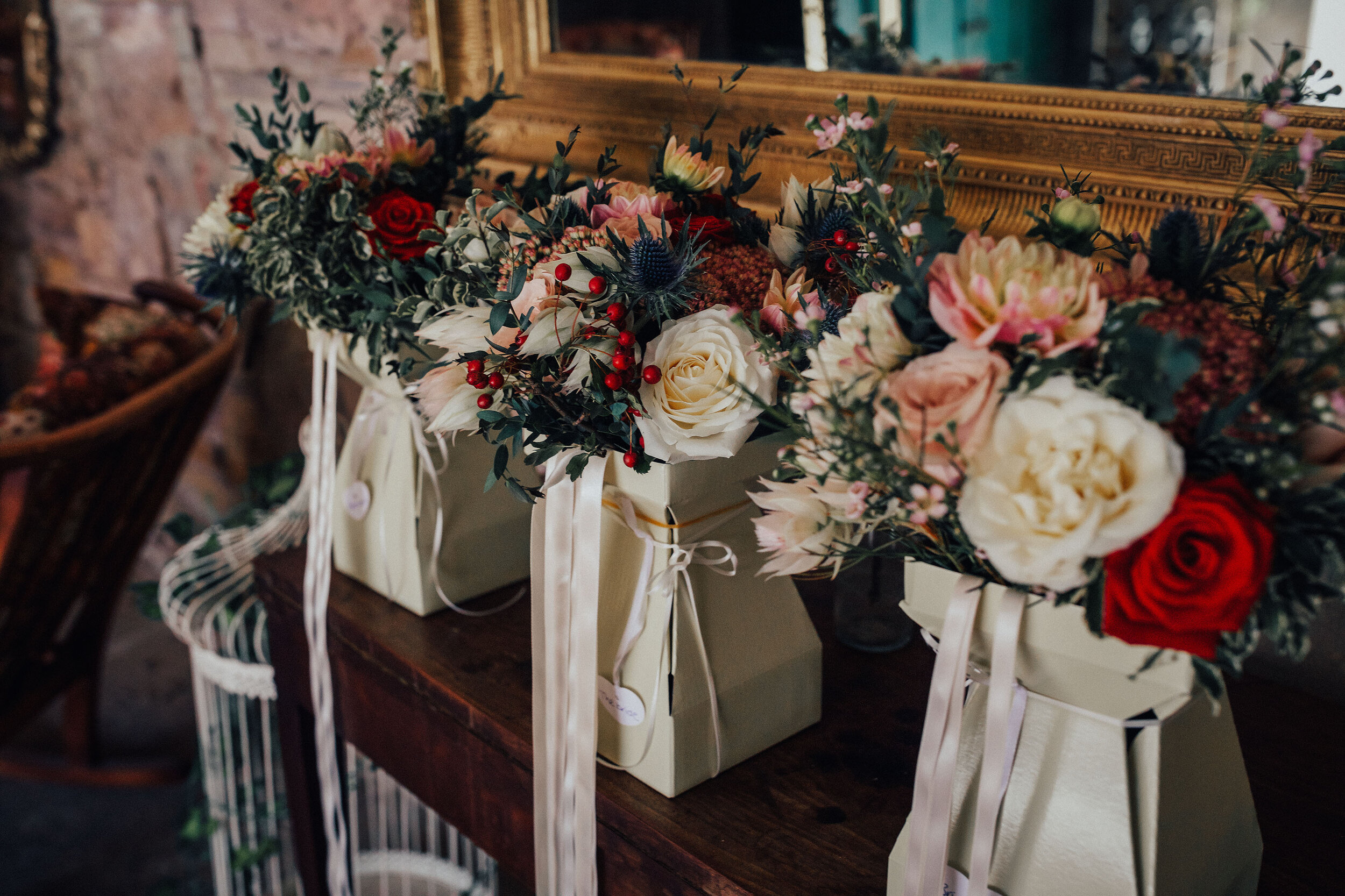 Beautiful wedding bouquets tied with pink ribbons in gift boxes 