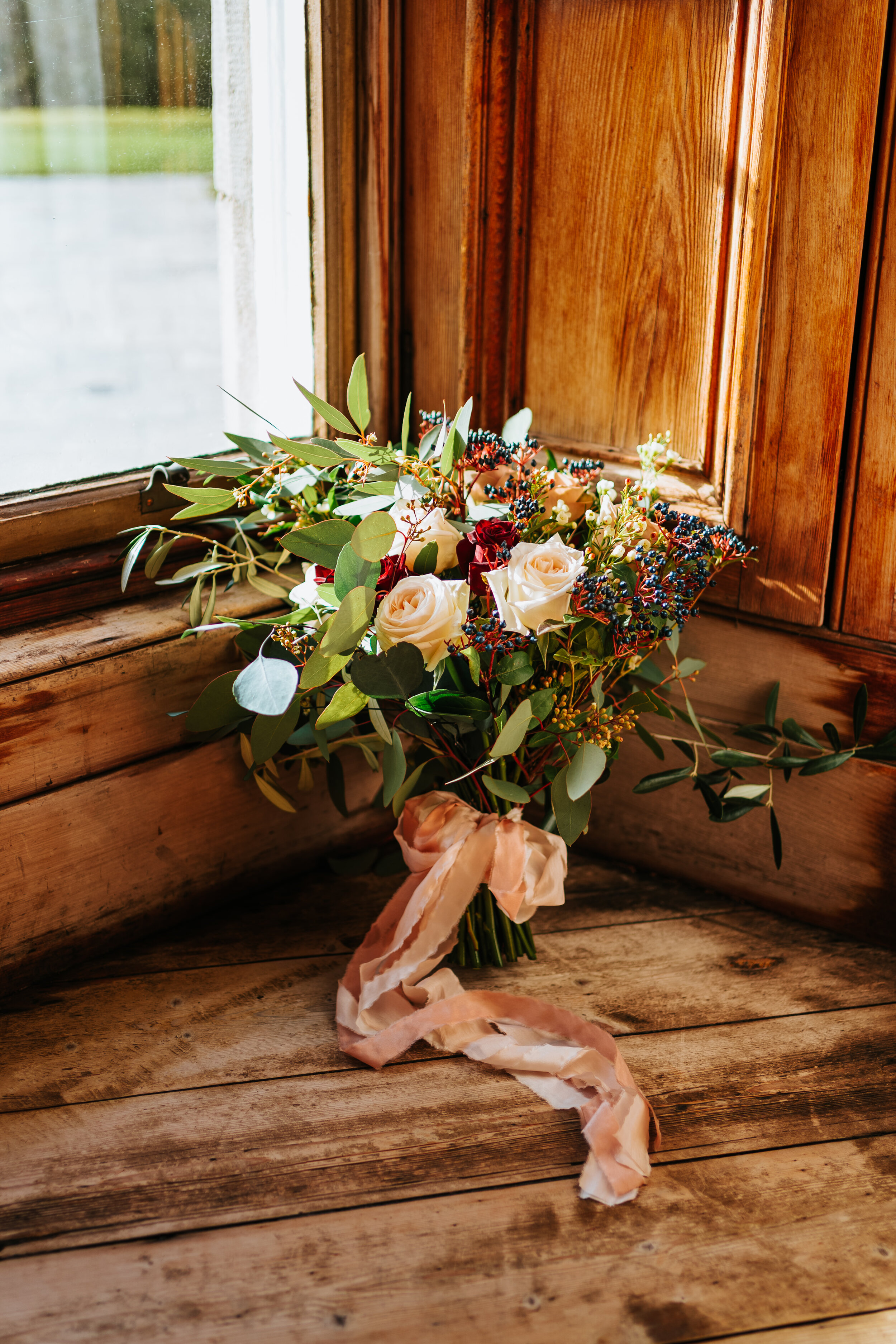 Hand Tied wedding bouquet by window at Newhall Estate