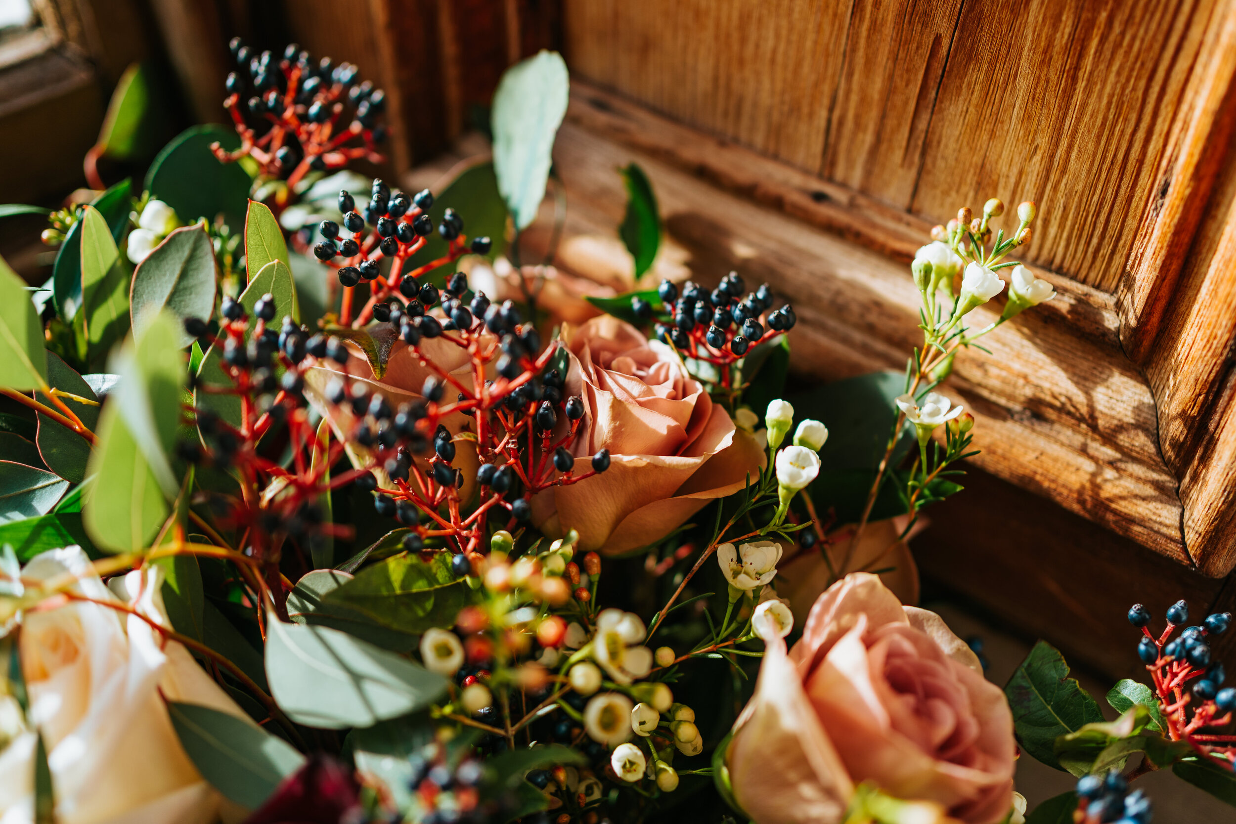 Wedding bouquet of berries, dusky pink roses and eucalyptus at Newhall Estate