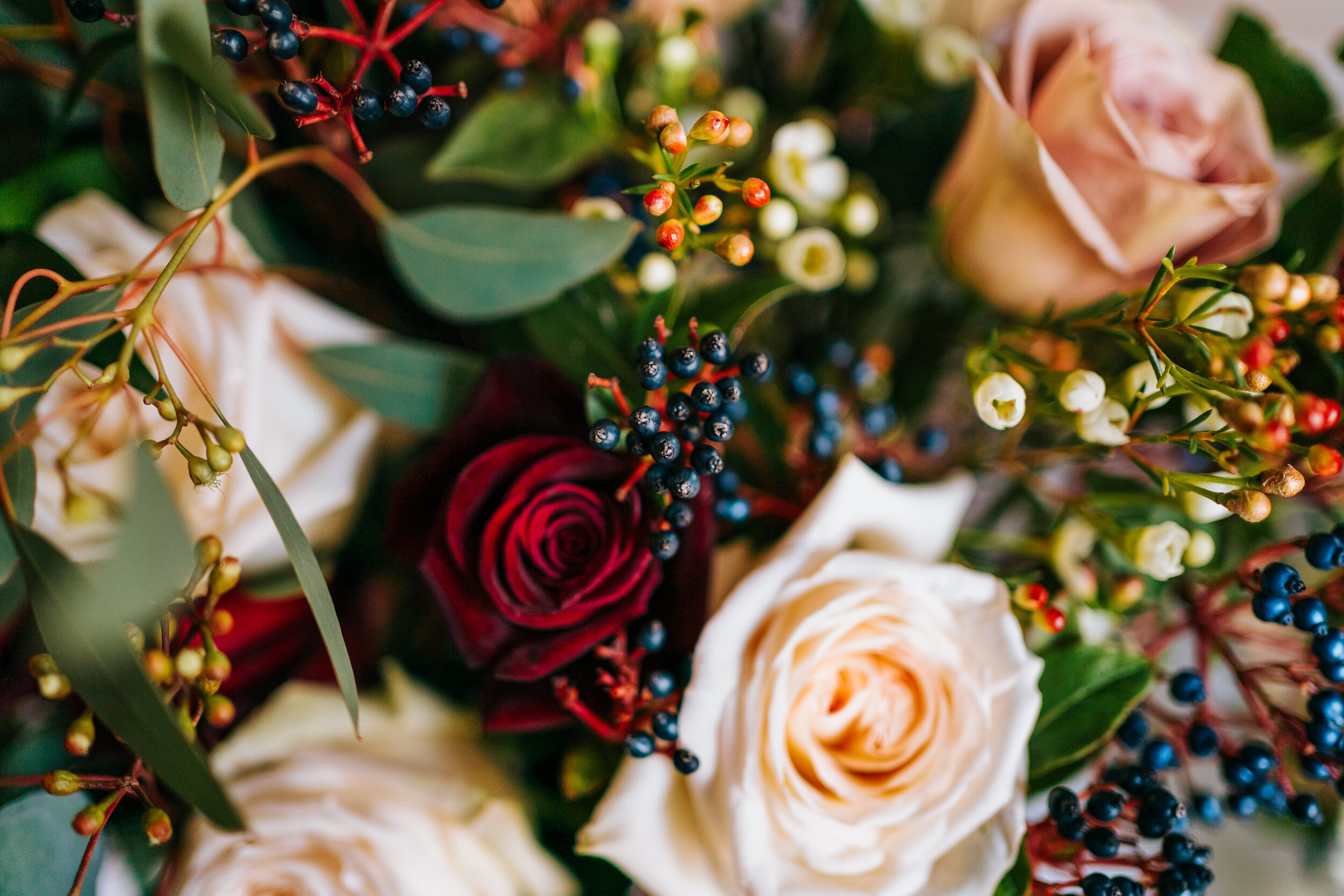 Wedding bouquet of roses and berries at Newhall Estate