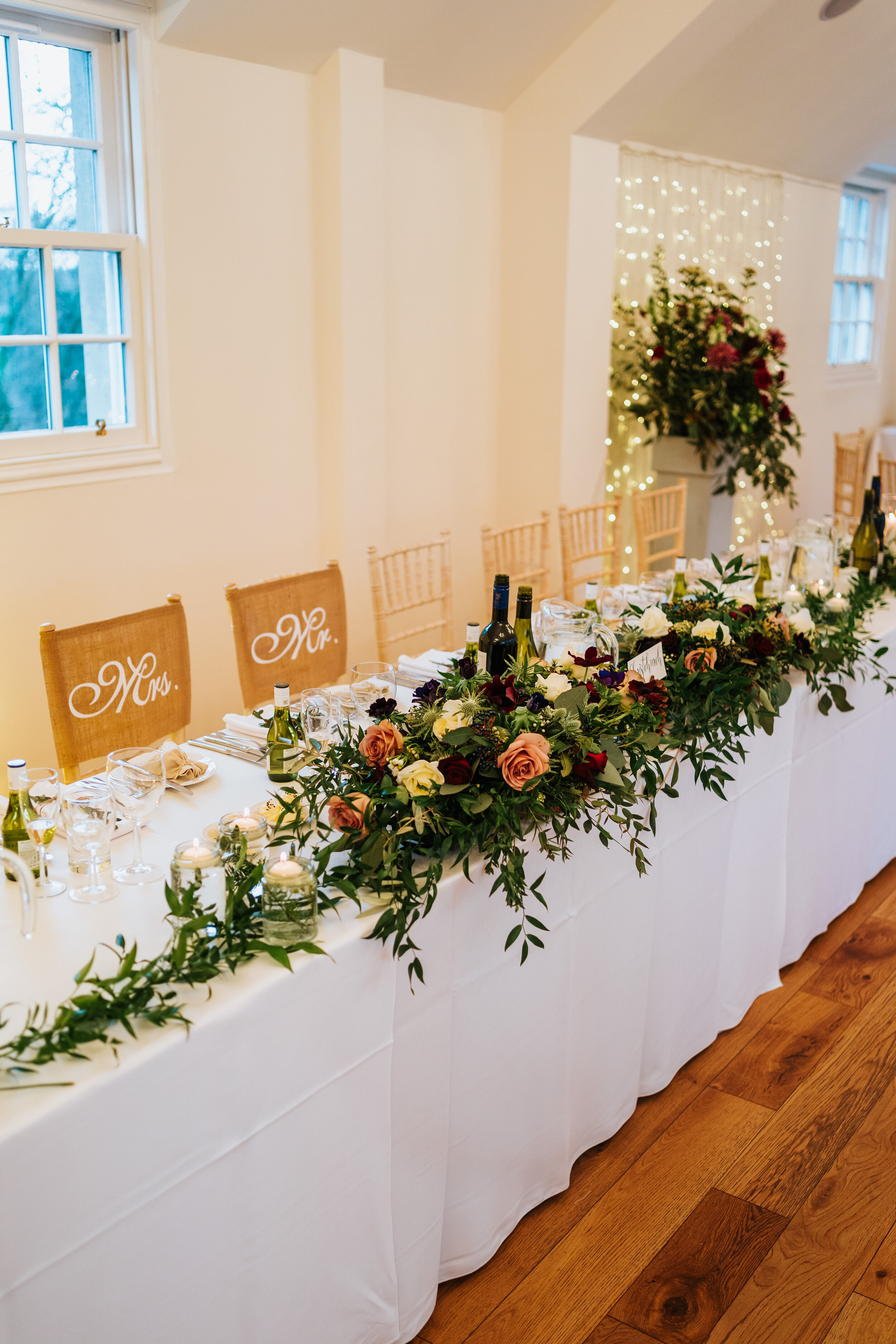 Top Table at Scottish wedding decorated with roses and foliage