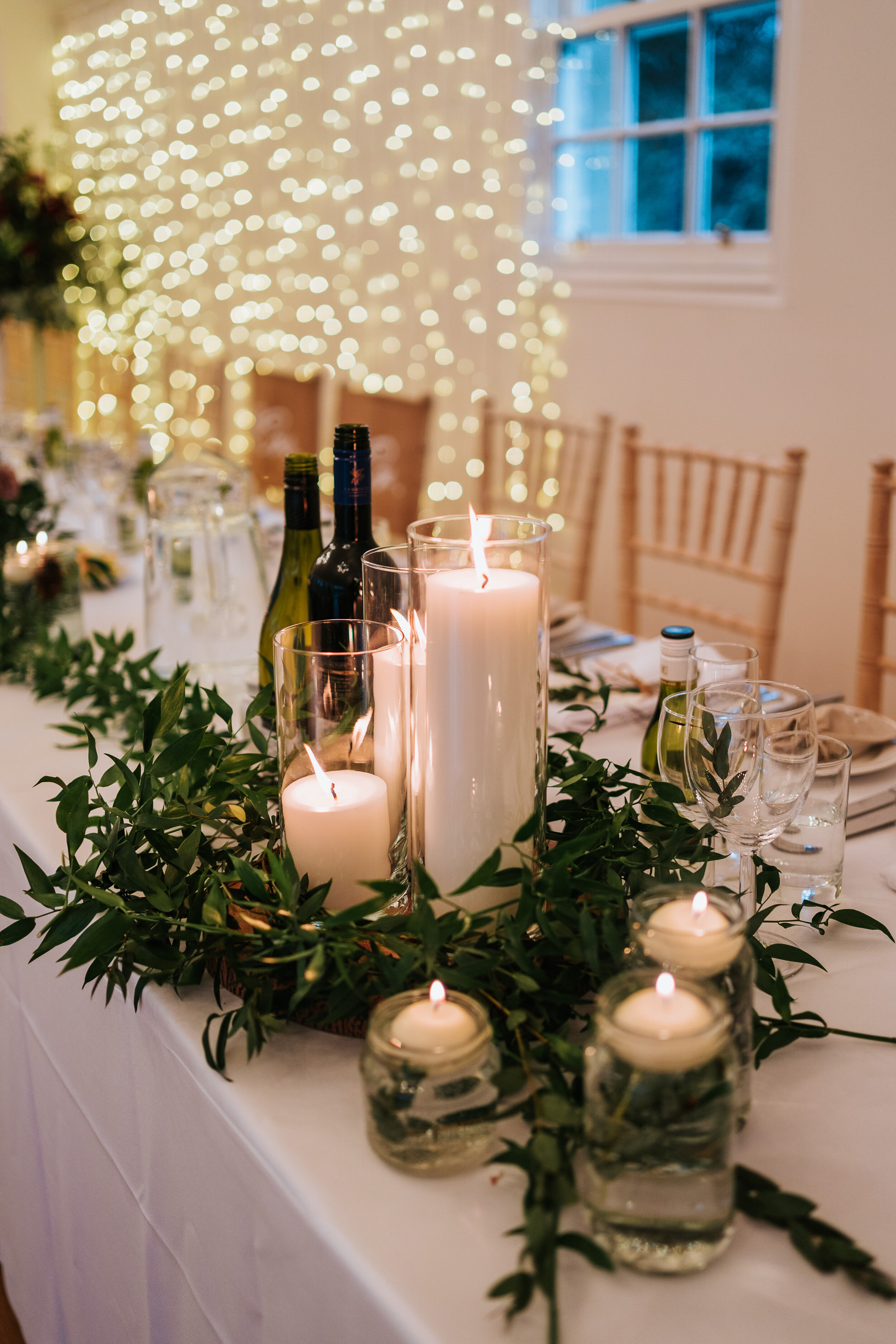 Table scape at Newhall estate of white candles and foliage