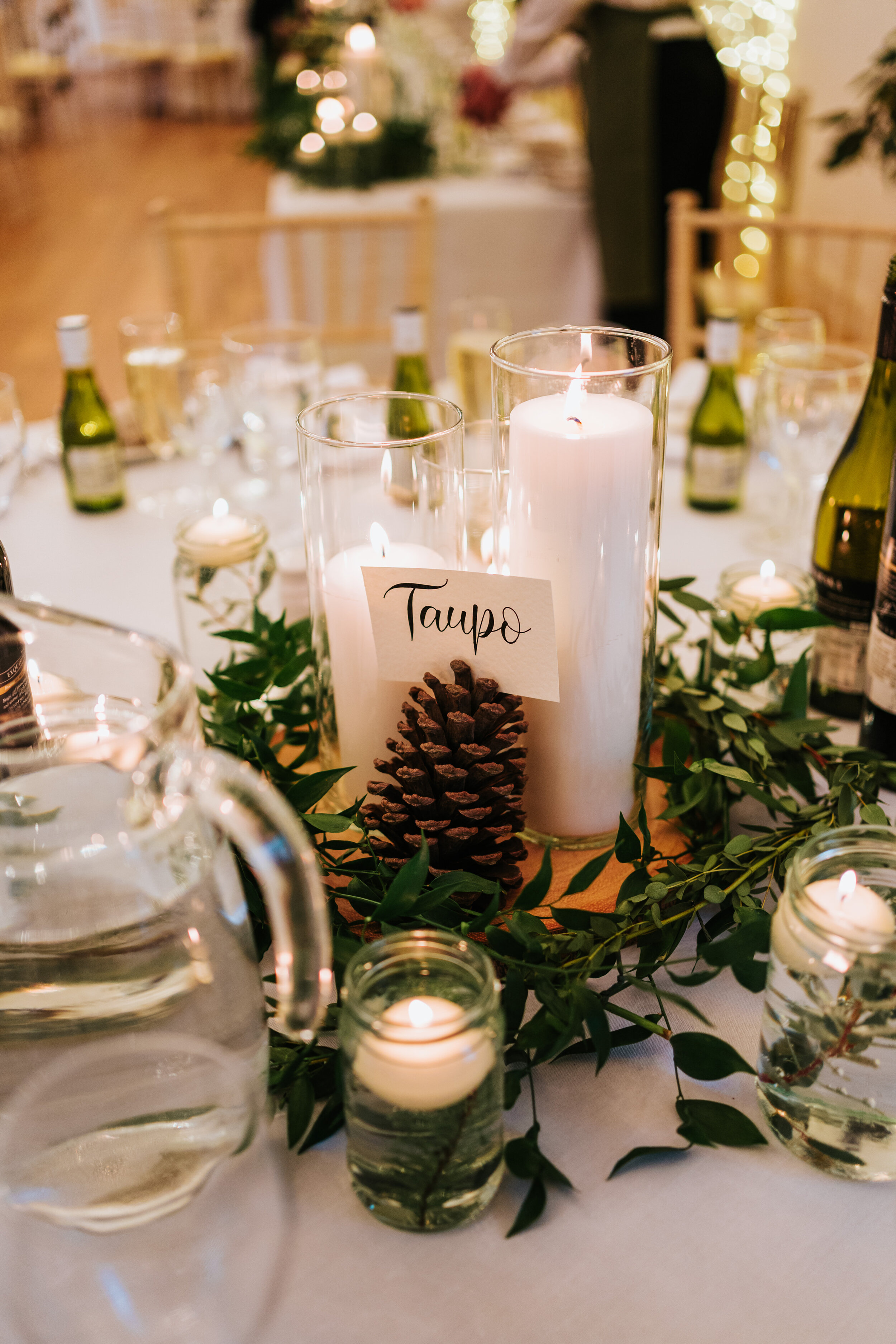 Table setting at Newhall estate with white candles, foliage and pine cones