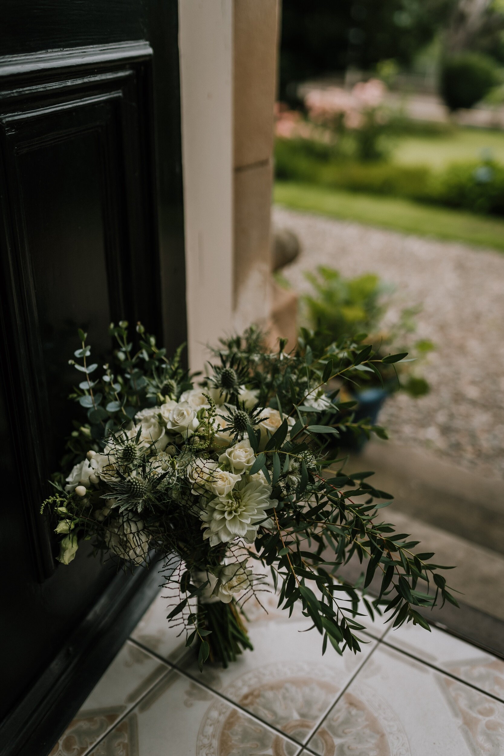 Hand tied wedding bouquet of white roses and foliage in Perthshire
