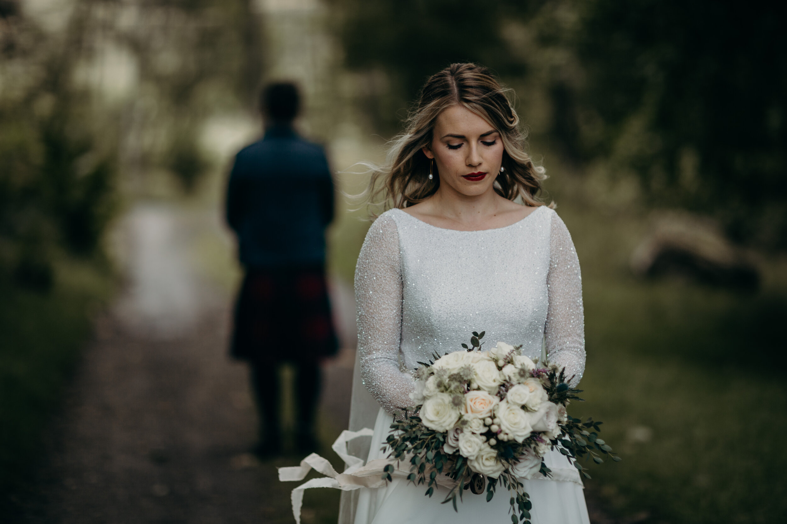 Bride holding white wedding bouquet at first look in Dunkeld 