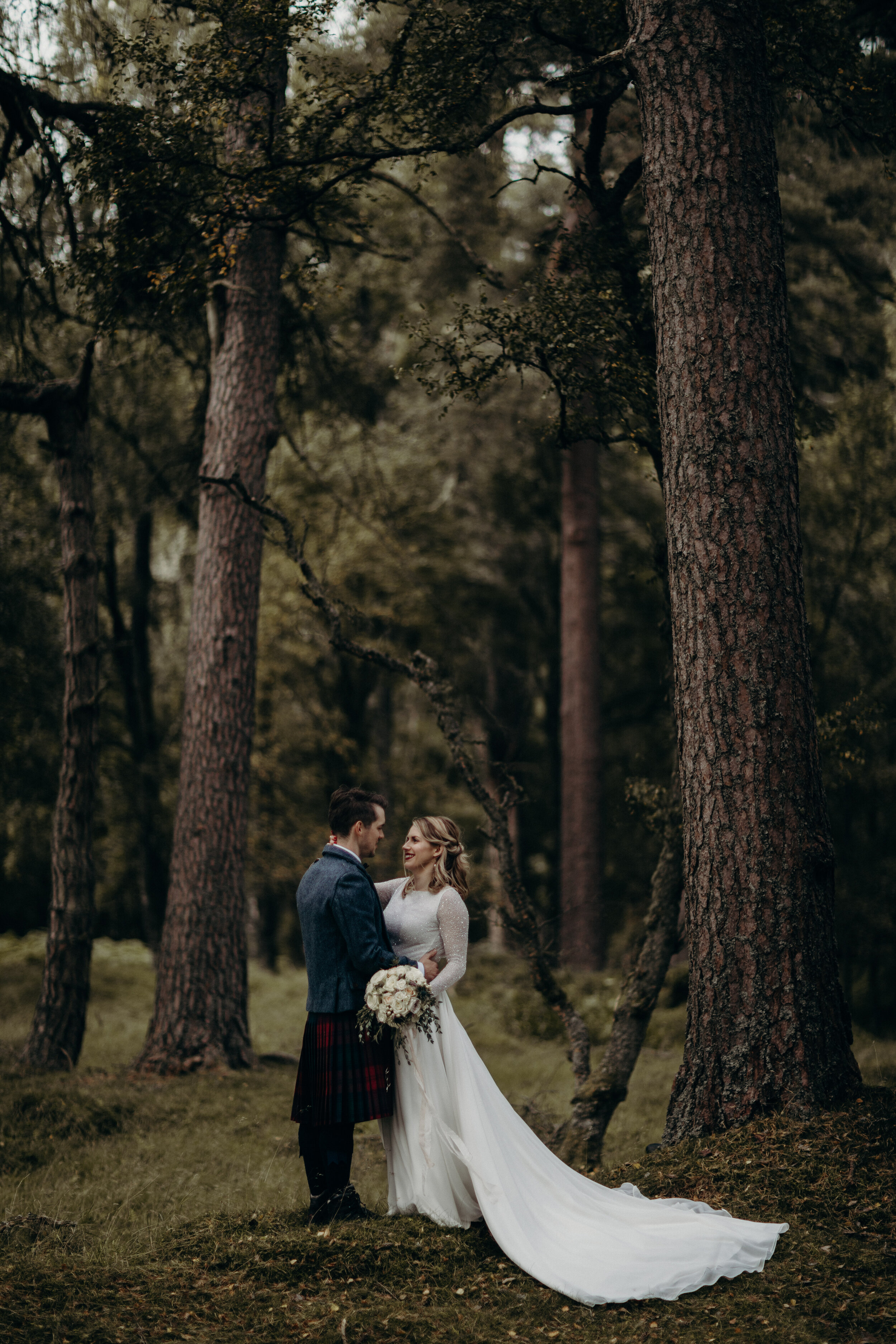 Bride and Groom standing in forest in Dunkled, Perthshire