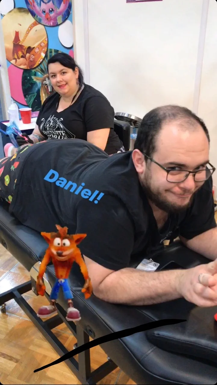 Kacey puts Daniel through his paces while doing a Crash Bandicoot tattoo!