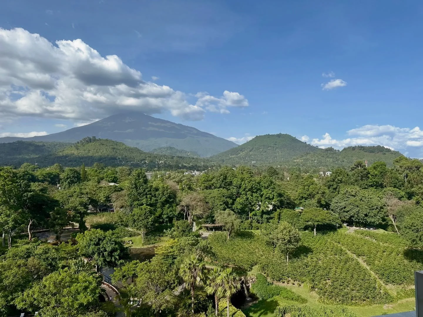 Mount Meru in the distance, Tanzania&rsquo;s second highest mountain. Popular with avid hiker&rsquo;s for training. It&rsquo;s a beautiful view, perfectly centered from the rooftop restaurant at Gran Melia Arusha. The rooftop restaurant offers a laid