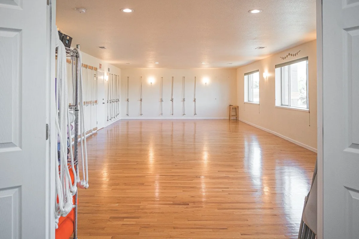 The Evolition Yoga and Fitness Studio space, with hardwood floors, natural light, and plenty of space.