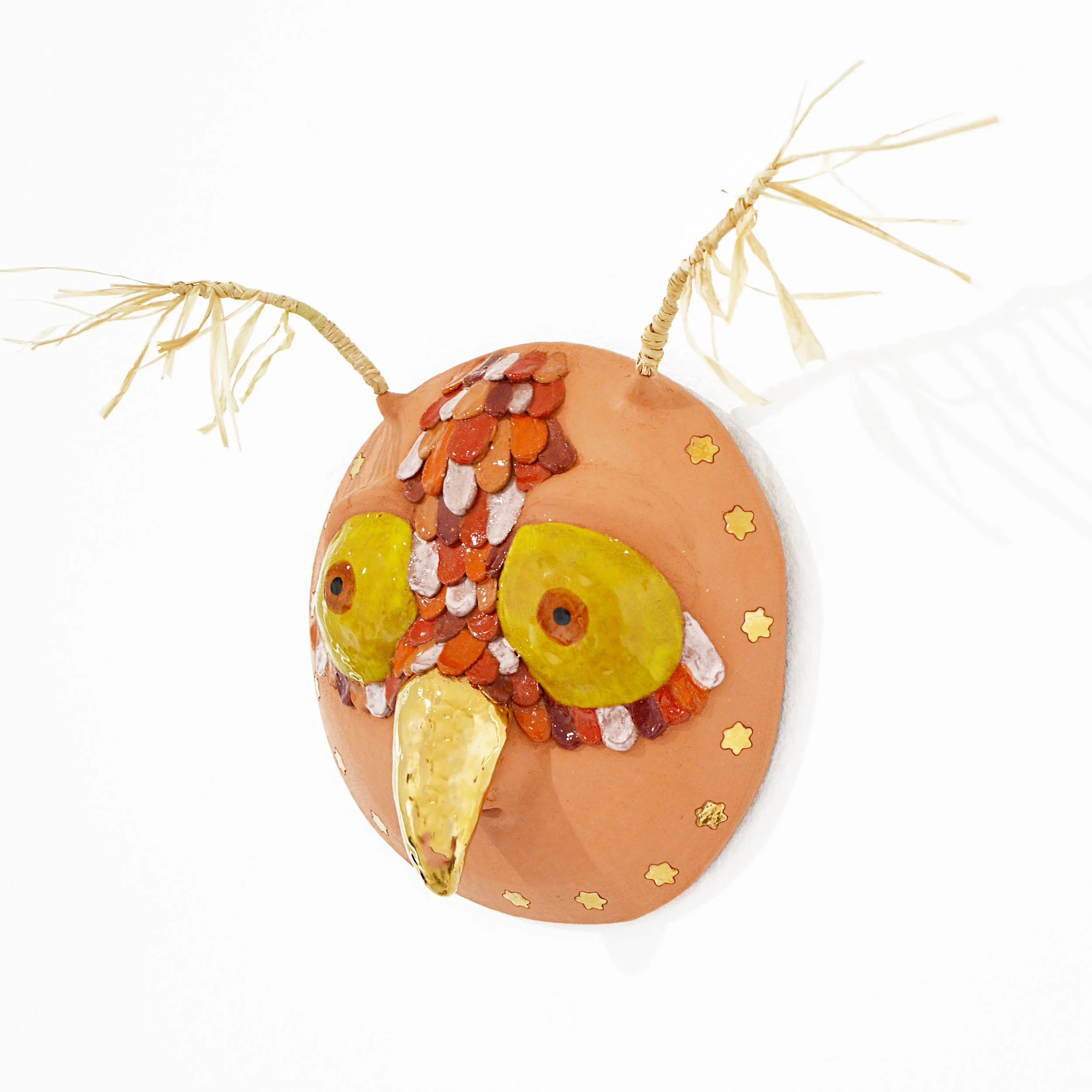 Owl Whistle Mask, 2026 Ceramic, glaze, gold luster, raffia, 10 × 15 × 6 in