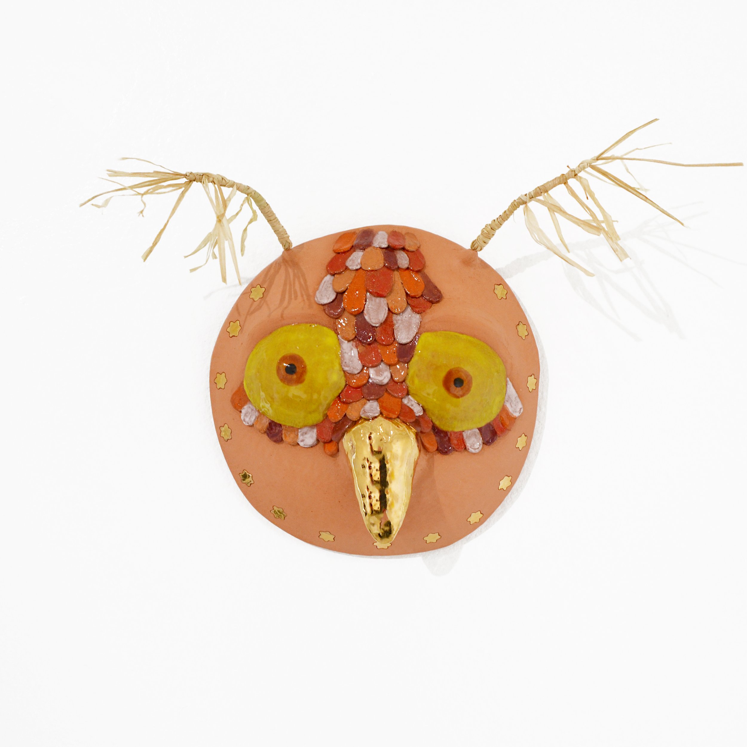 Owl Whistle Mask, 2026 Ceramic, glaze, gold luster, raffia, 10 × 15 × 6 in