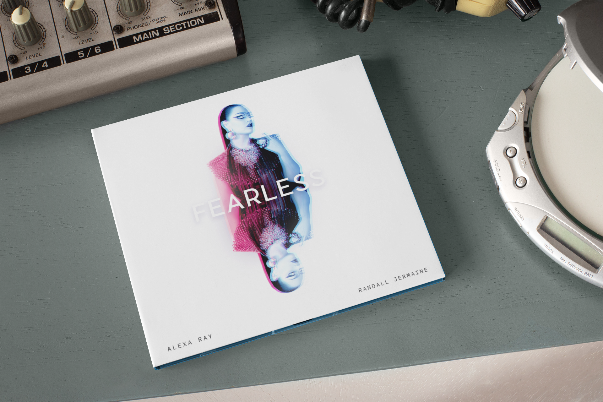 mockup-of-a-digipak-on-a-desktop-next-to-a-cd-player-28347.png